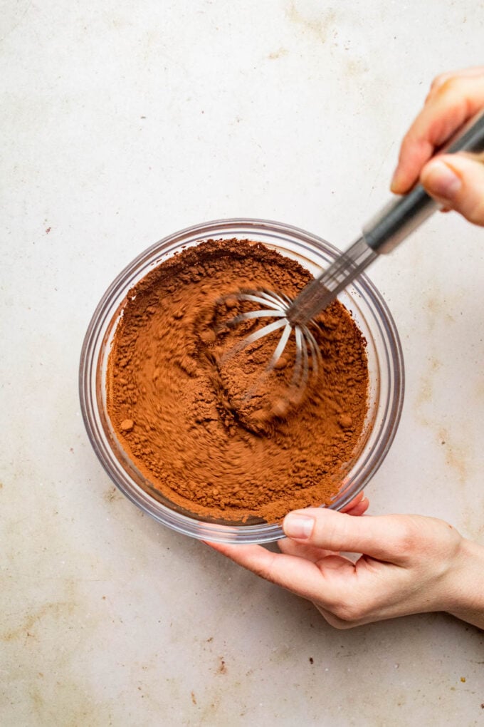 hand whisking cocoa in bowl