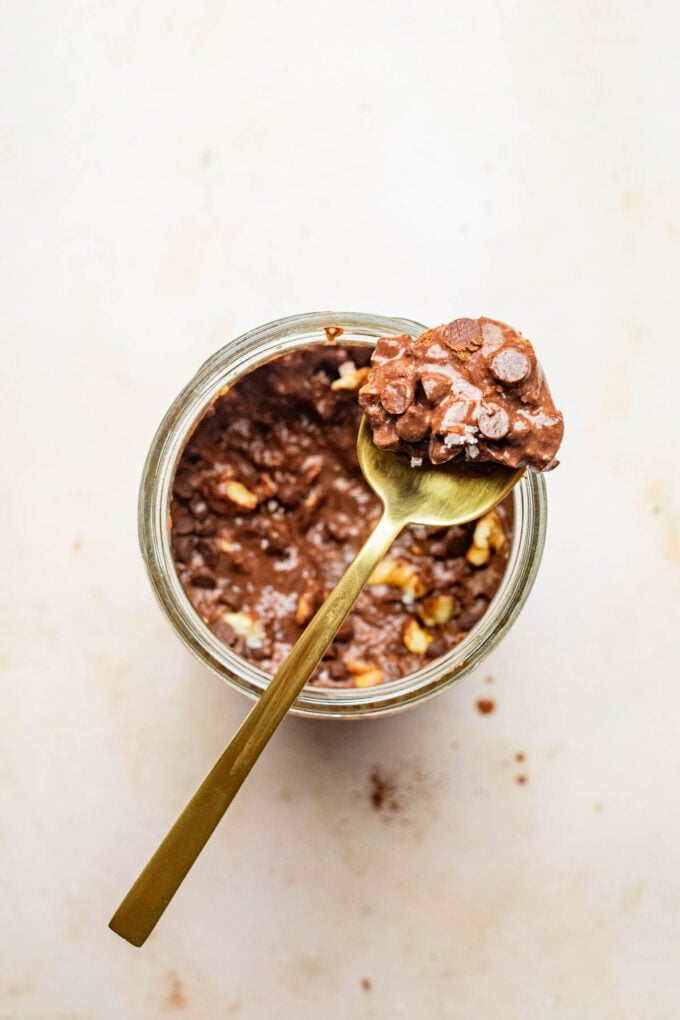 brownie batter overnight oats on spoon and jar