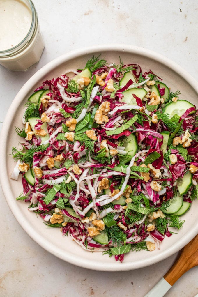 quinoa and herb salad in bowl with dressing