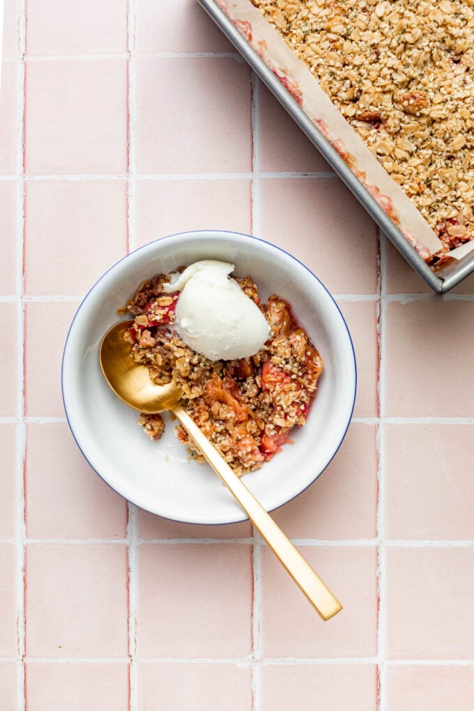 rhubarb crisp in bowl with ice cream