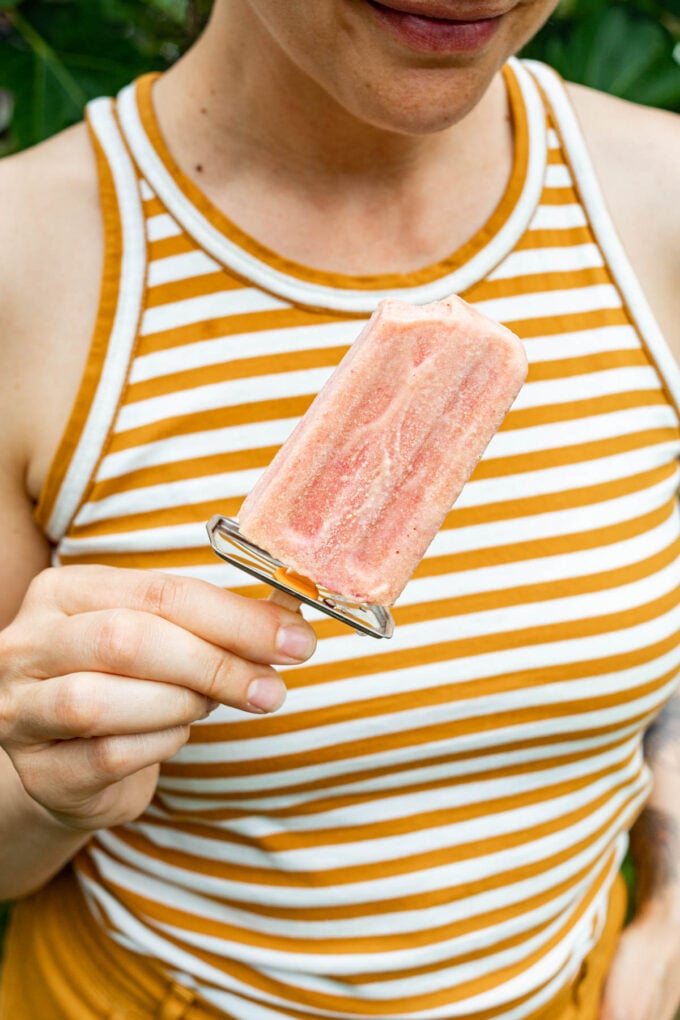 woman holding popsicle