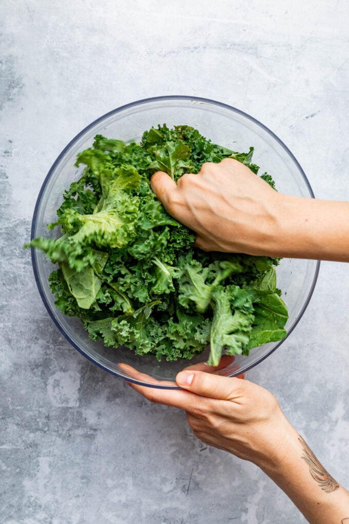 hand massaging kale