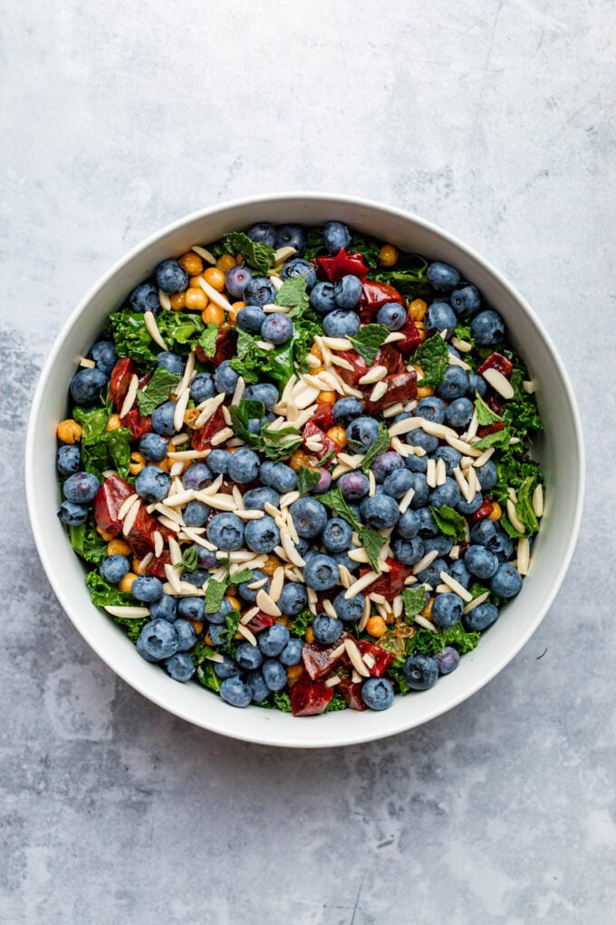 blueberry kale salad in white bowl