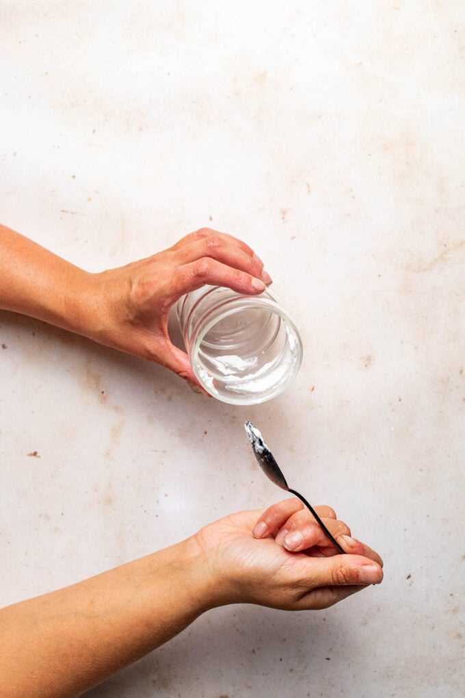 hand spooning coconut cream into glass