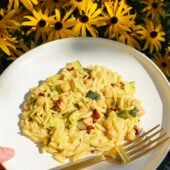 plate of zucchini orzo and flowers