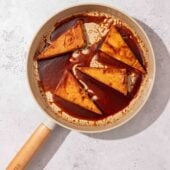 brown sugar glazed tofu steaks in beige skillet