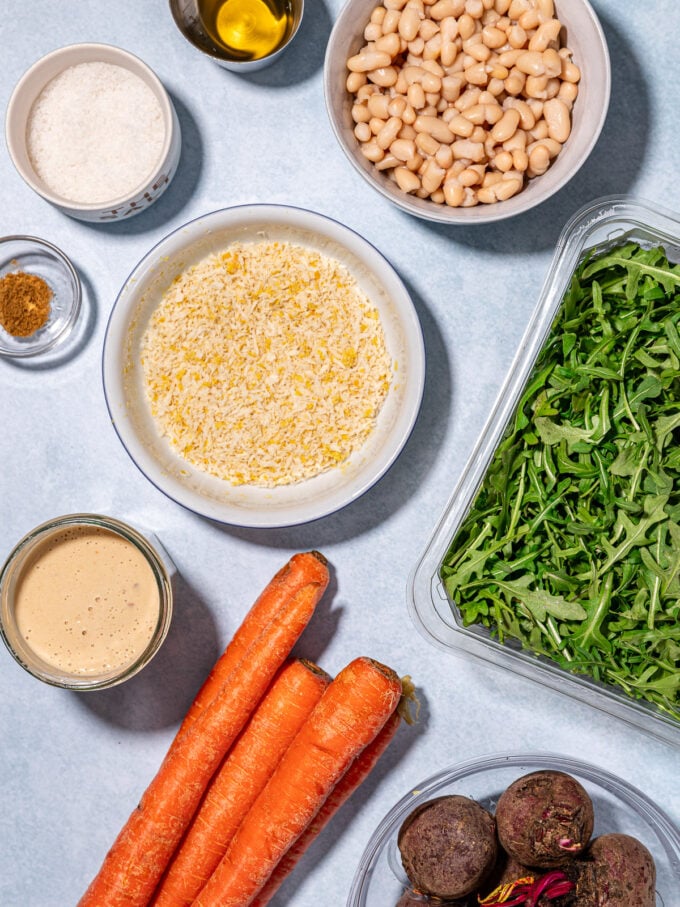 carrots, arugula, beets and bread crumbs in bowls