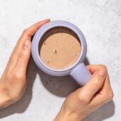 hands holding mug of hot chocolate