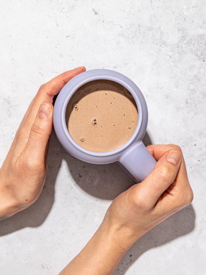 hands holding mug of hot chocolate