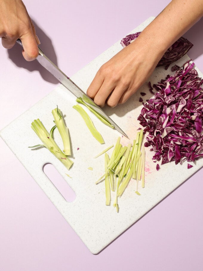 hand chopping broccoli stalk