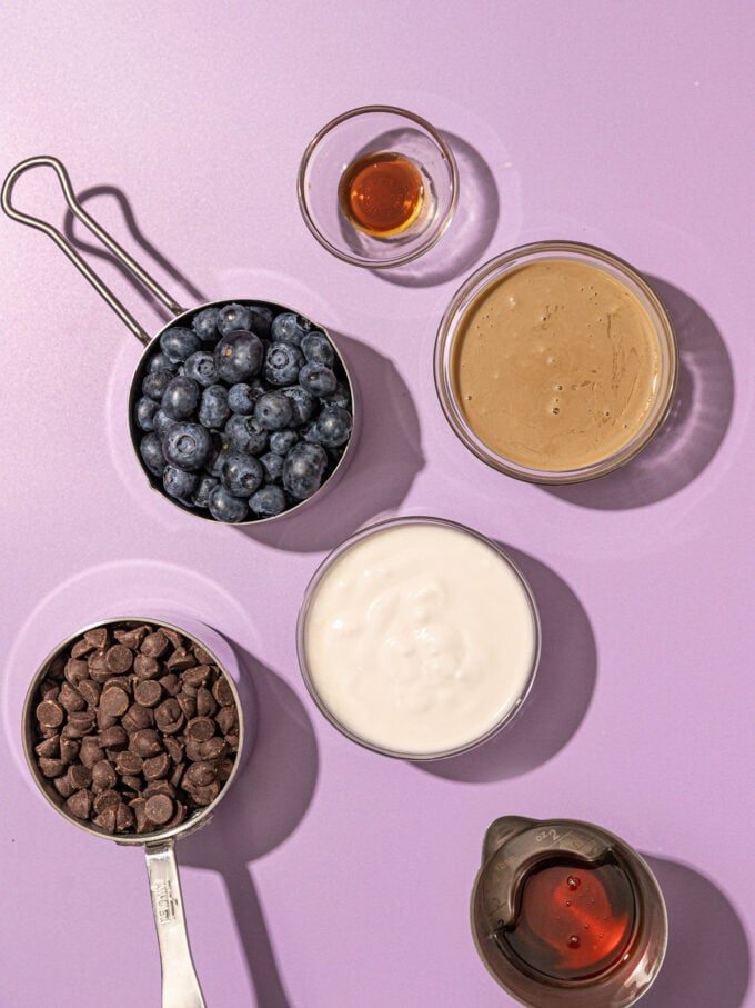 blueberries, yogurt, chocolate chips and tahini in bowls