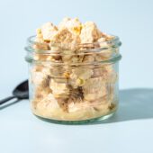 crumbled tofu feta in glass jar with black spoon