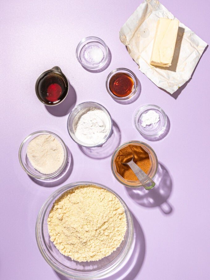 almond flour, cinnamon, butter and maple syrup in bowls