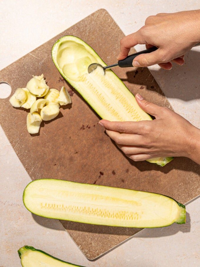 hand scooping zucchini