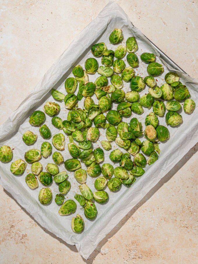 brussels sprouts on a parchment lined baking sheet
