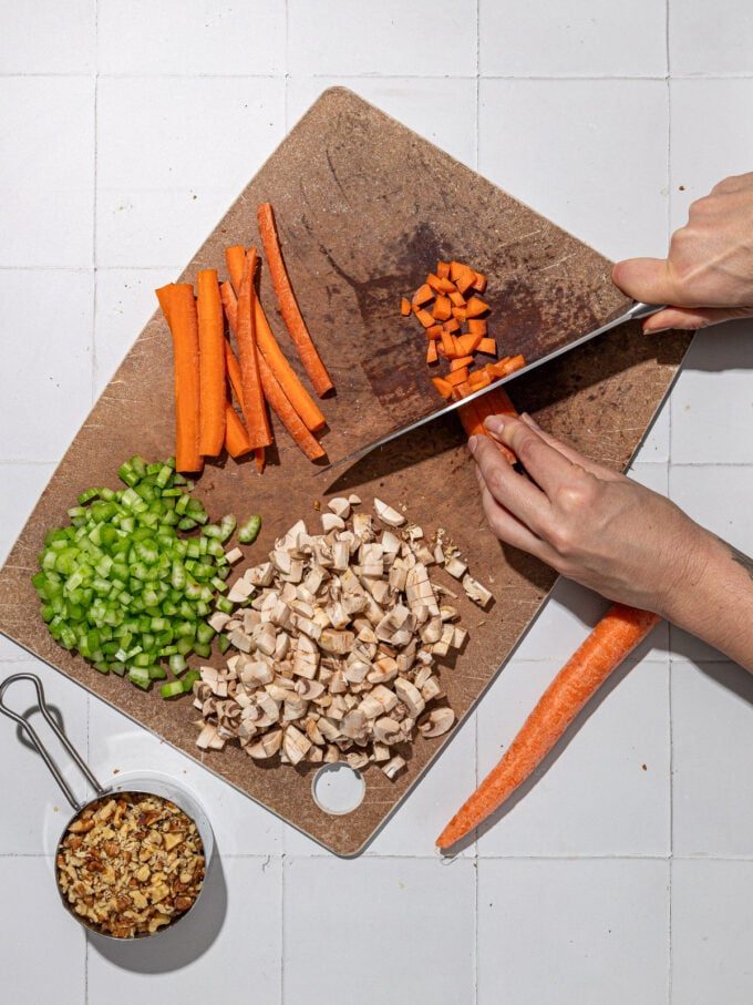hand dicing carrots, celery and mushrooms