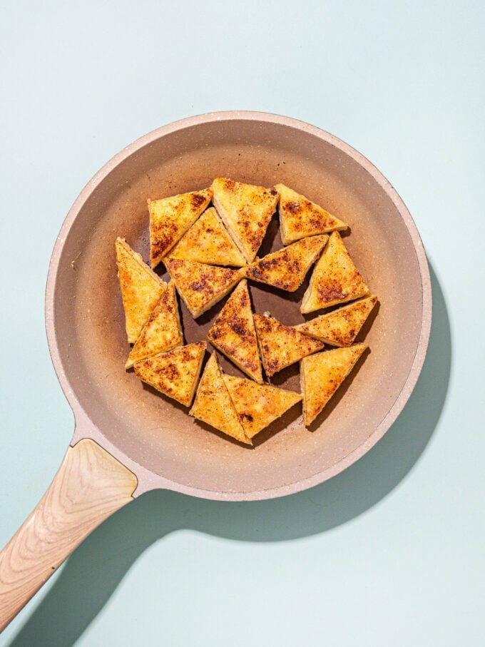 pan-fried tofu in beige skillet