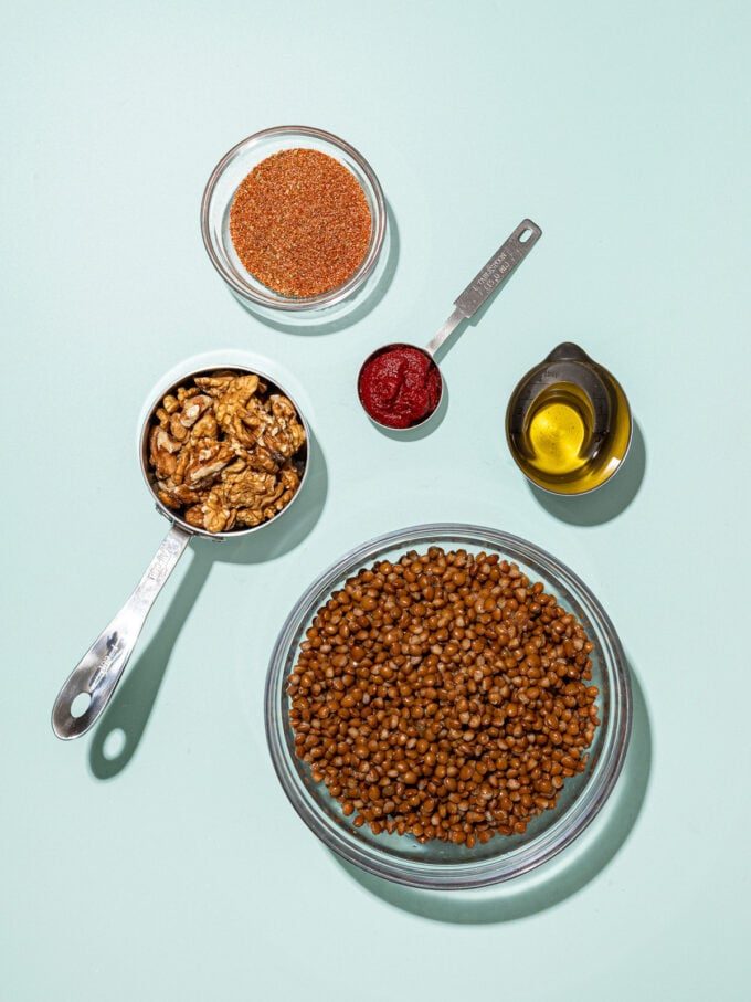 glass bowl of lentils with cup of walnuts, taco seasoning, tomato paste and oil