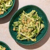 green goddess shredded cabbage and chickpea salad in 3 blue bowls