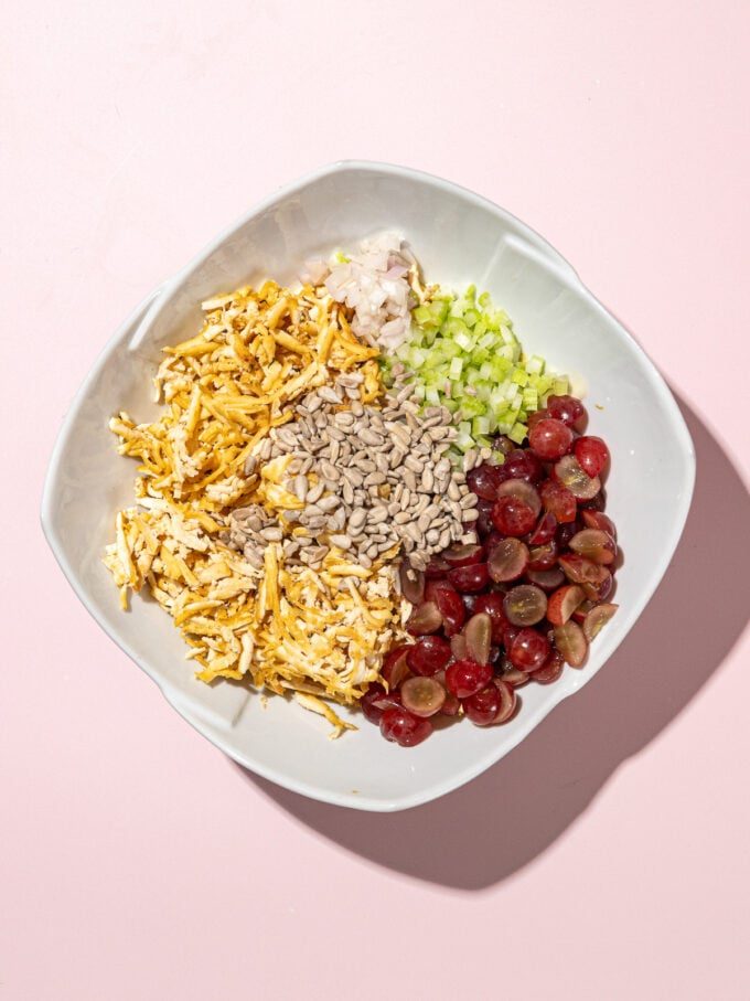 bowl of shredded baked tofu, sunflower seeds, diced celery, sliced red grapes and mayo dressing