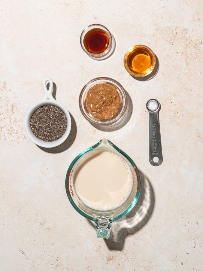 small bowls of soy milk, almond butter, chia seeds, salt, vanilla