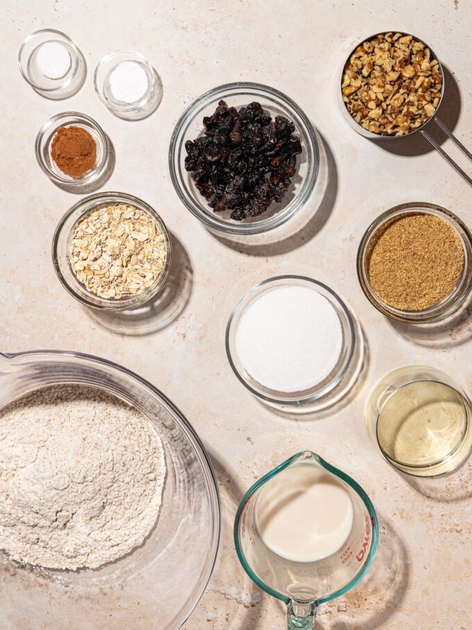 small bowls of prune cookie ingredients: diced prunes, walnuts, flax, oats and cinnamon