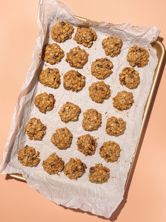 baked oatmeal raisin cookies on parchment lined baking sheet